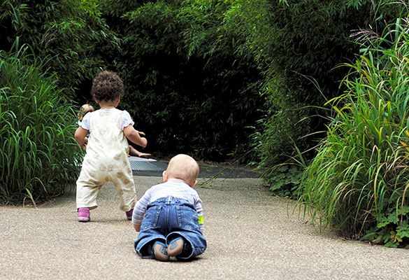 baby crawling and toddler walking away
