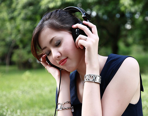 person sitting outside using headphones