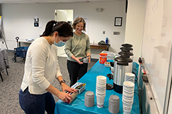 two employees setting up conference room 