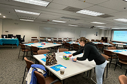 employee setting up training room 