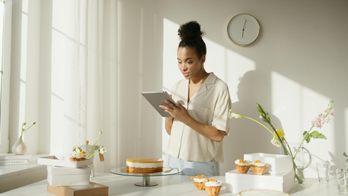 woman in kitchen looking at tablet