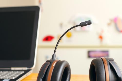black and brown headset near laptop