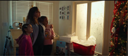 woman and children looking at christmas tree