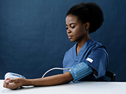 Woman using blood pressure device