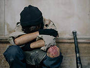 Homeless child with head down