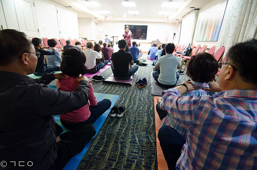 group sitting on yoga mats