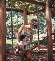 woman pushing child on a swing