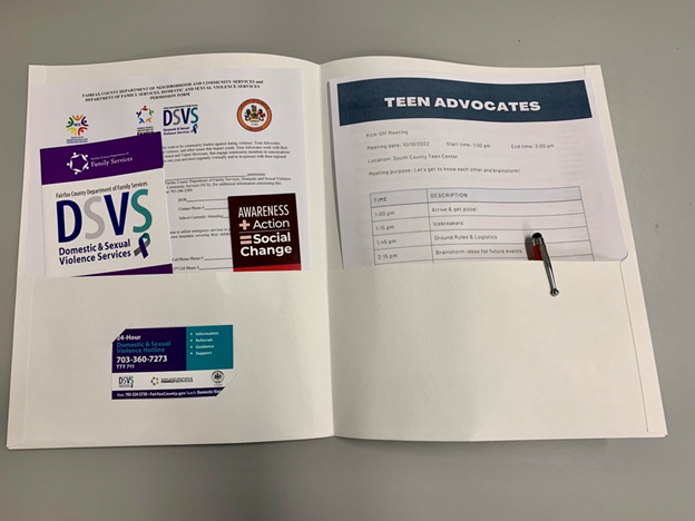 open folder with DSVS paperwork and teen advocates flyer