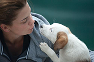 woman kissing dog