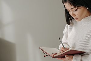 Woman writing in a notebook