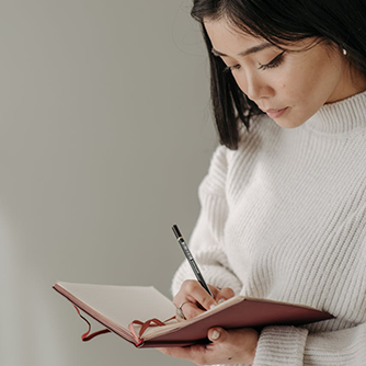 woman writing in journal 