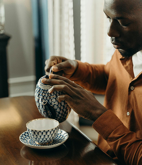 man pouring a cup of tea