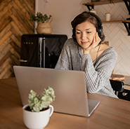 Woman with headphones looking at computer