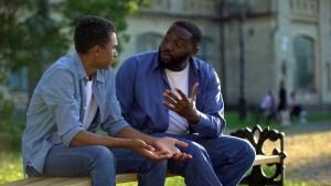 men on a bench talking