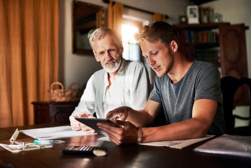 father and son looking at tablet