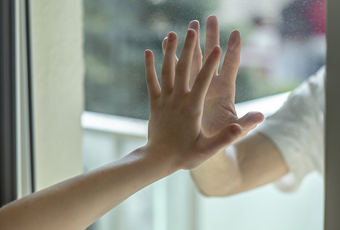 children hands touching window