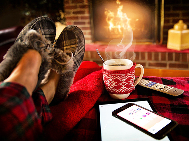 legs crossed on ottoman in front of fireplace