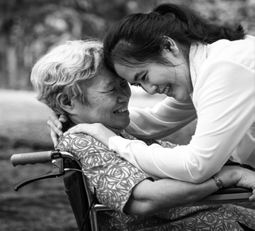 older adult and adult smiling