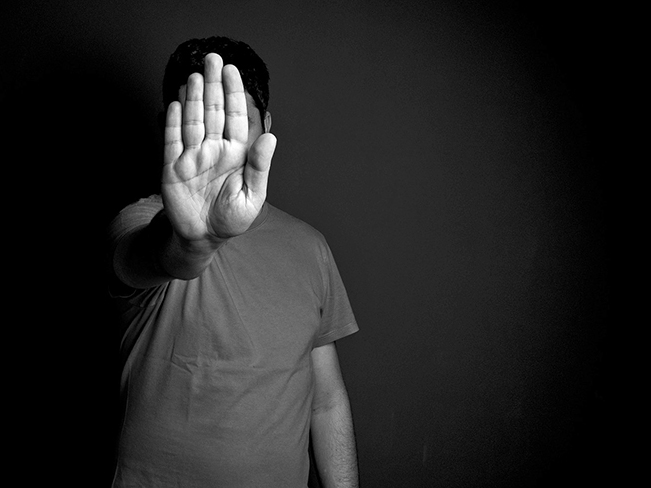 person standing with arm in front palm faced out