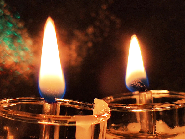 two candles burning side by side