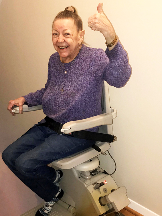 stairlift with person riding