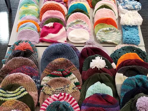 knit winter hats in different colors and sizes