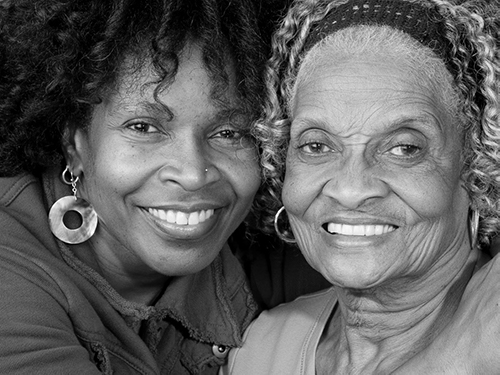 older adult and their parent smiling