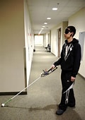 person demonstrating "white cane" robotic use