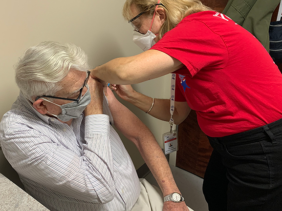 person sitting getting vaccination