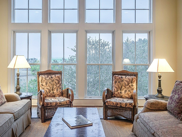 sitting area with two chairs, lamps, sofas and one coffee table