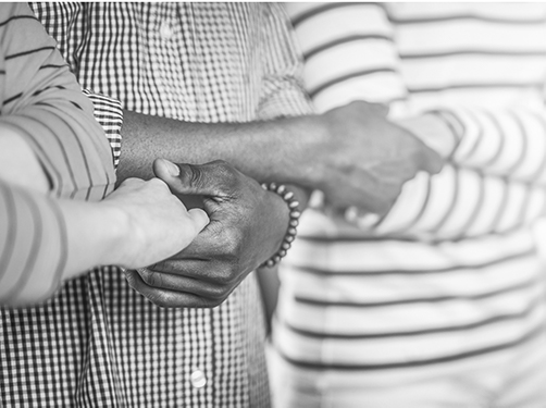 three different sets of hands interlocking with each other