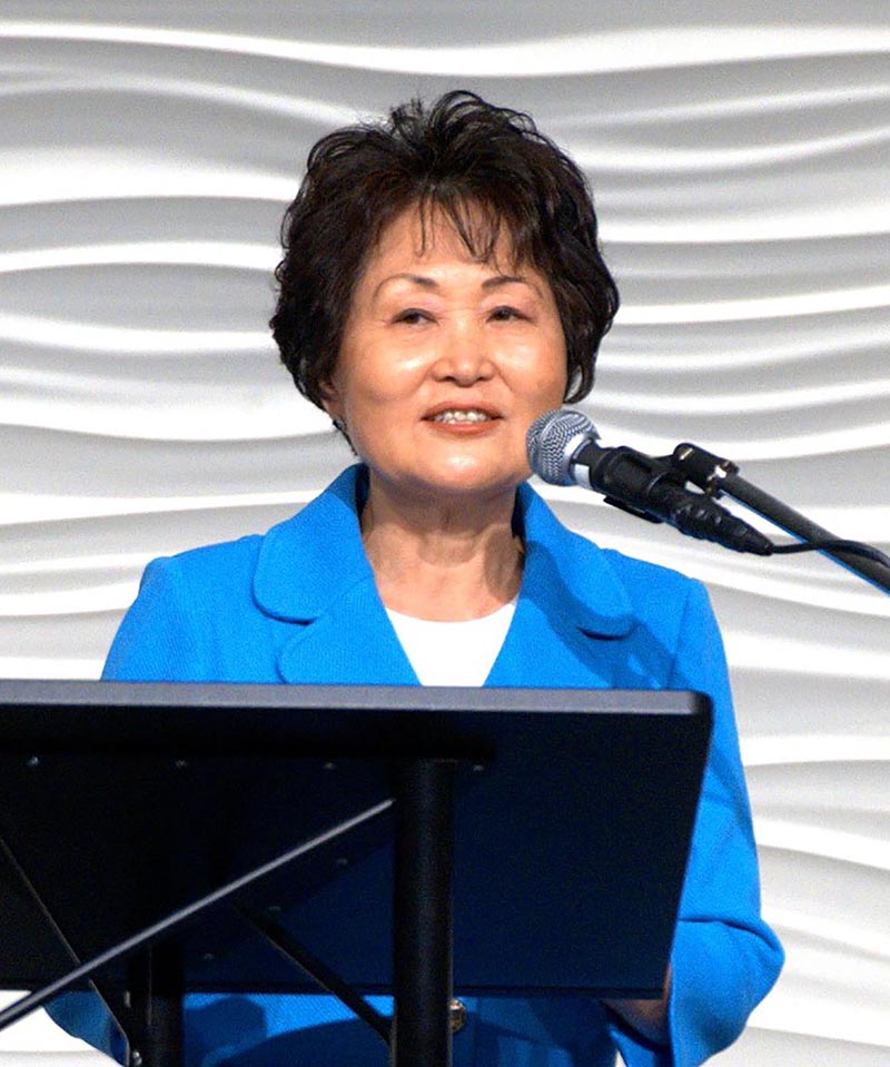 Photo of Dr. Heisung Lee speaking at a podium