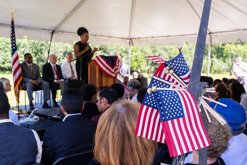 Photo of a naturalization event inside an outdoor tent