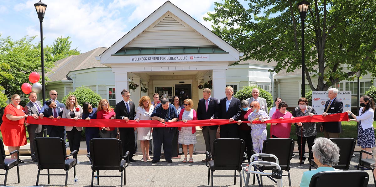 Photo showing dignitaries gathered to cut the ribbon to open the Wellness Center for Active Adults.