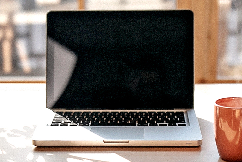 Photo of an open laptop sitting on a desk
