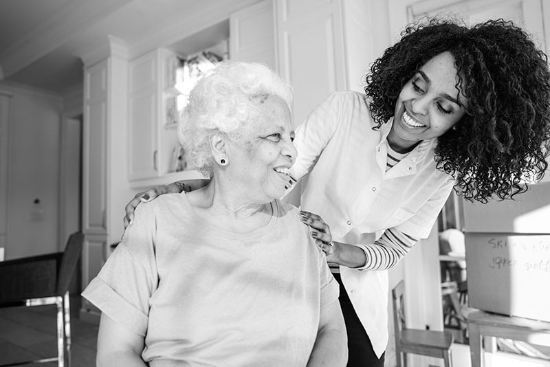 Photo of a young woman caring for an older woman