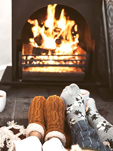 feet warming by fireplace