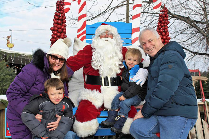 Jerry and Michelle Shapiro pose for a photo with Santa with grandsons Cayden and Cameron. 