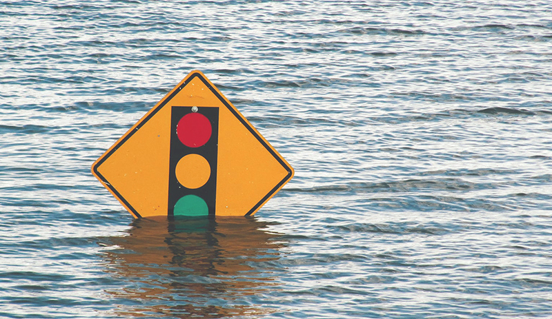 Photo of a traffic sign submerged in flood waters