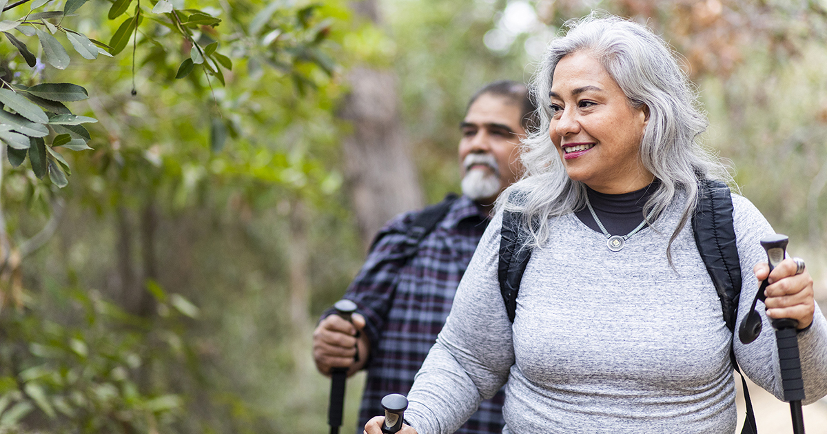 Photo of a woman and man hiking in the wilderness.