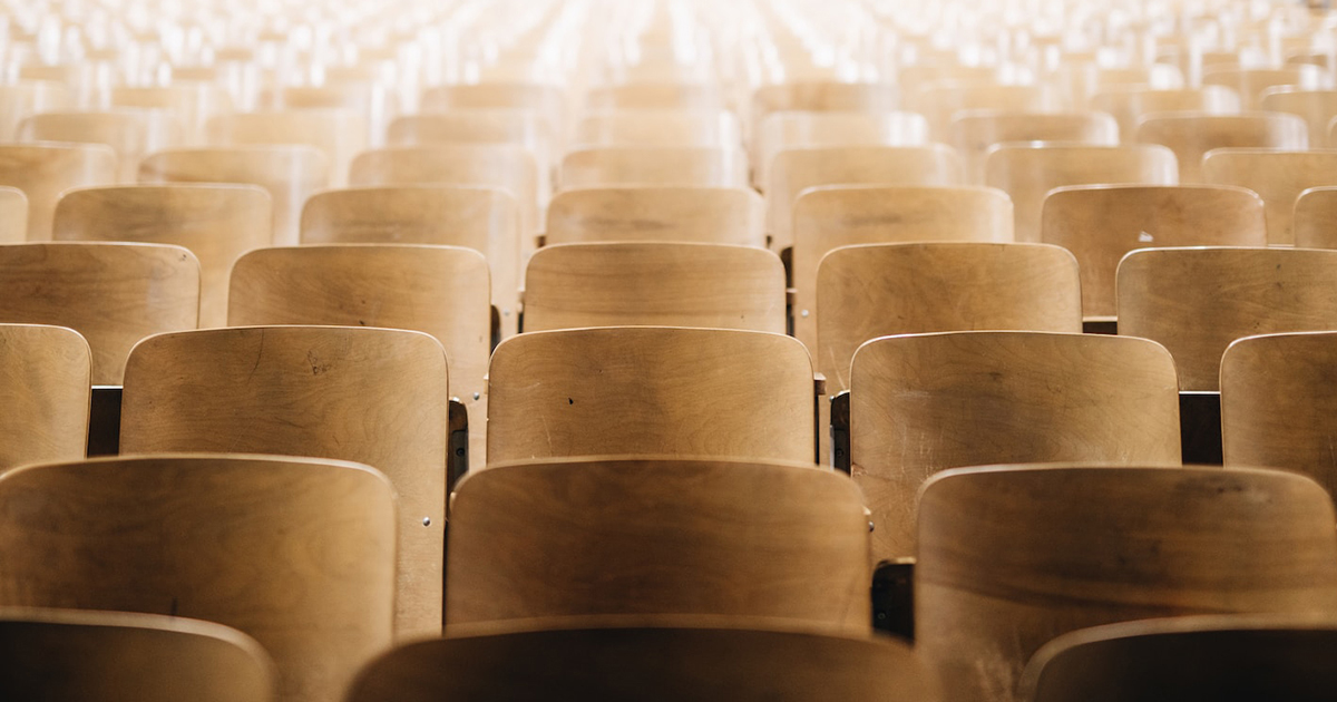 Photo of an empty college classroom filled with stadium-style seating.