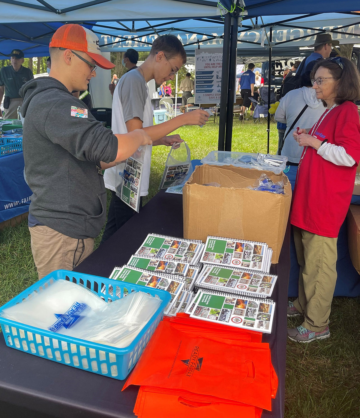 Volunteers with the Emergency Management Volunteer Corps working at a public outreach event.