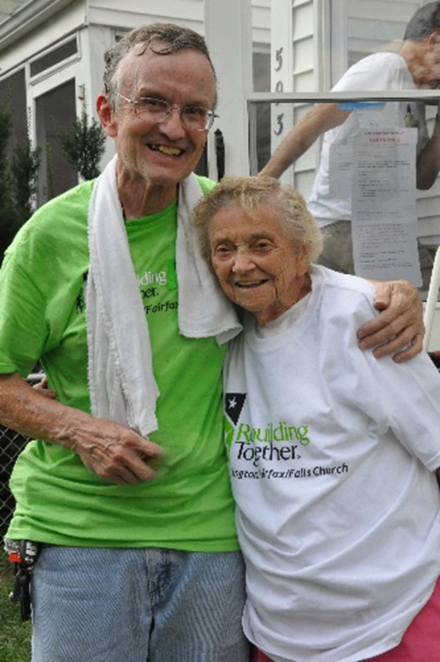 Photo of a Rebuilding Together volunteer with his arm around an older woman