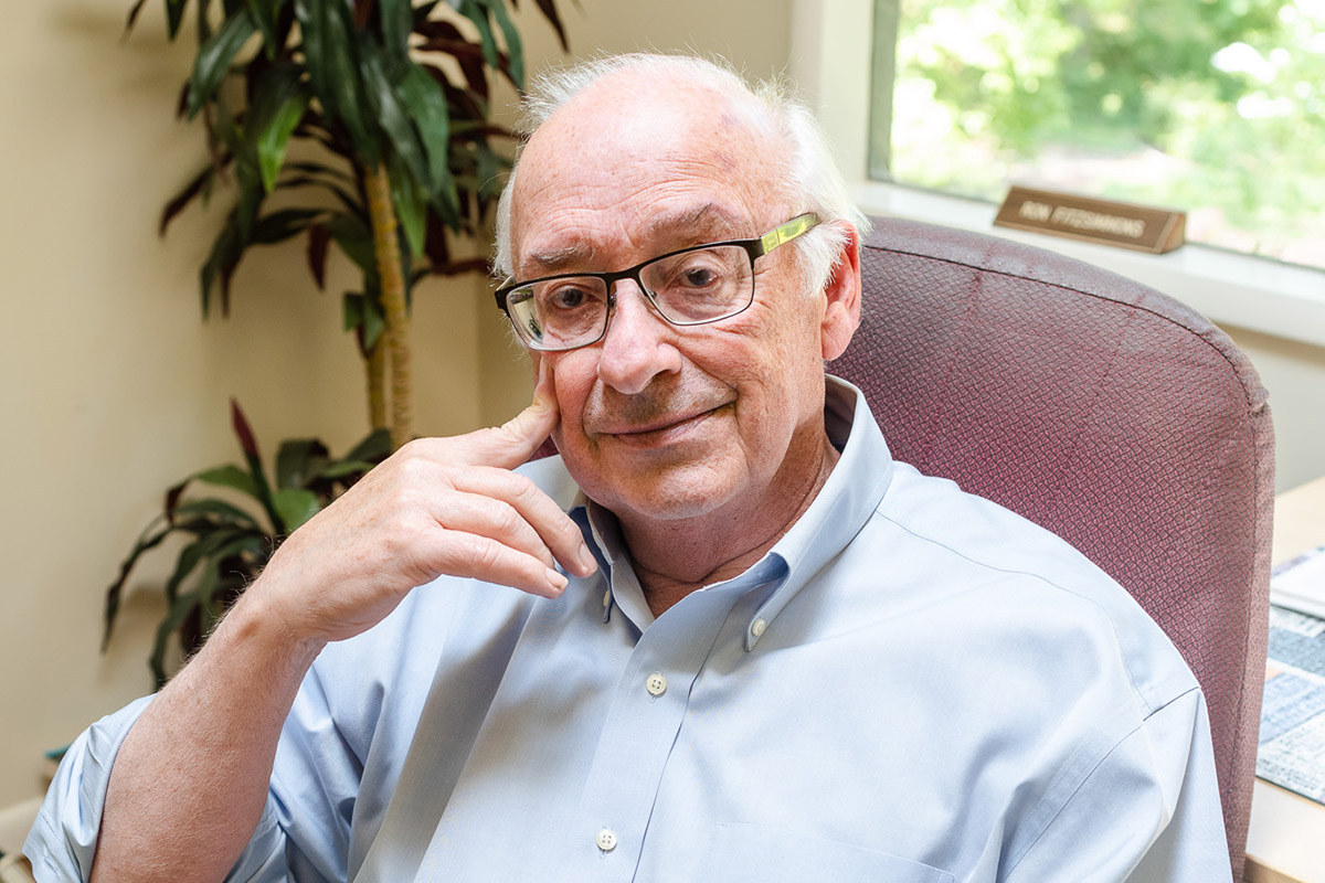 Ron Fitzsimmons sitting in a chair by a window.