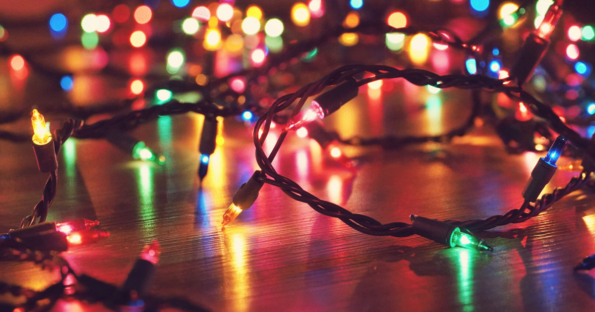 Photo of colorful string lights spread accross a floor.