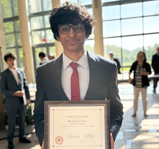 Photo of Advik Atyam holding the plaque he received as winner of the 2024 Shark Tank Challenge.