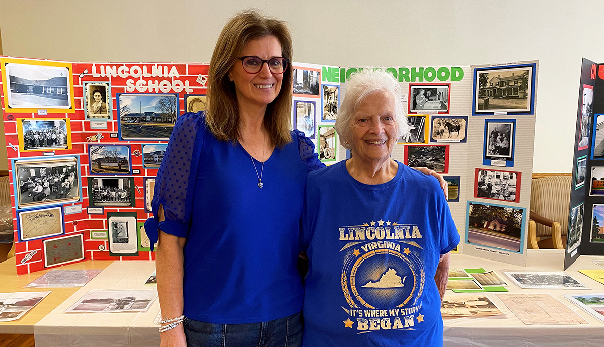 Photo of Debi and Jill Gerald at Lincolnia Senior Center standing in front of a display they made.