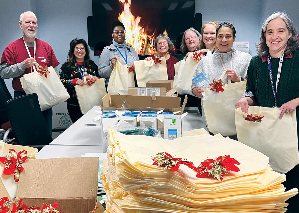 Jim Hickey, (Fairfax County Health Department Medical Reserve Corp volunteer), Carol Wright (A&A staff), Alycia Blackwell (DFS staff), Sarah Shannon (Rotary Club of Bailey's Crossroads), Jeannine Deem, Emily Swenson, Nadia Hoonan and Jodi Smith (A&A staff) gathered to assemble the gift bags.