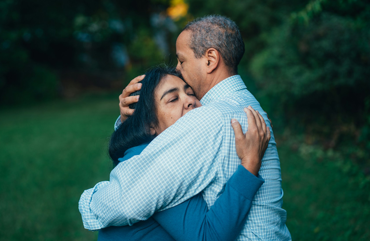 Photo of a man and woman embracing each other in comfort.