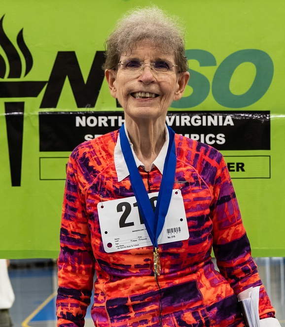Photo of Mandy Whalen smiling and wearing a medal at the 2023 NVSO games.